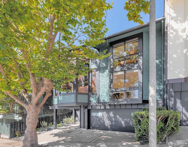 exterior space with a garage, fence, and driveway