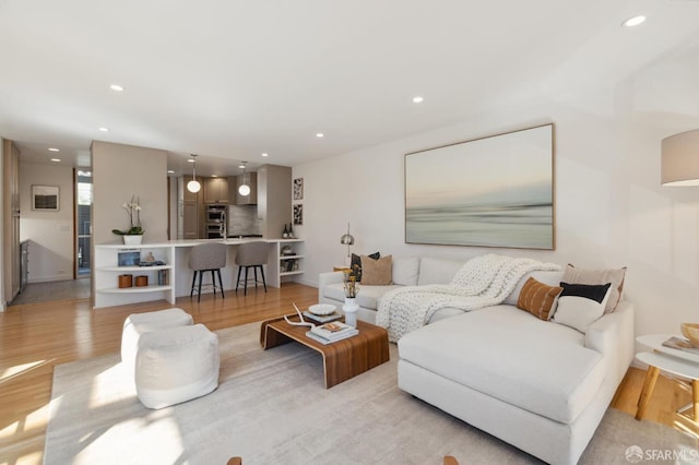 living room featuring light wood finished floors and recessed lighting