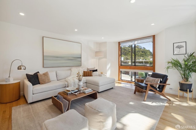 living room with wood finished floors and recessed lighting