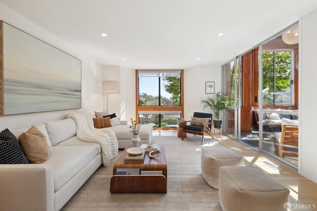 living area featuring expansive windows and recessed lighting