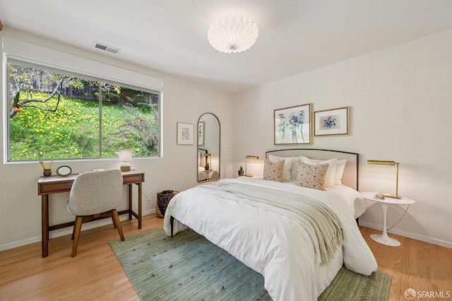 bedroom featuring baseboards and wood finished floors