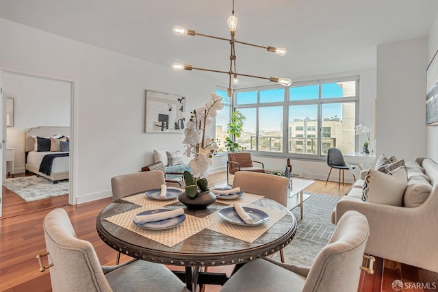 dining area featuring an inviting chandelier and light wood-type flooring