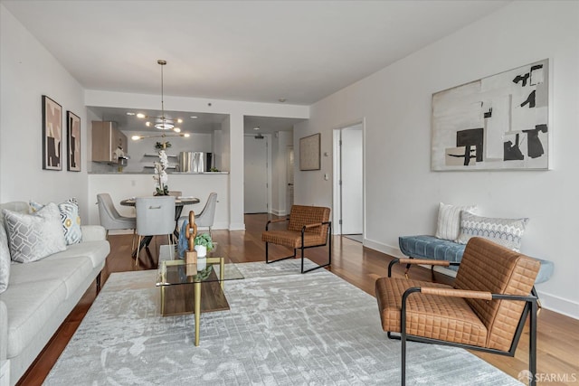 living room with a notable chandelier and hardwood / wood-style floors