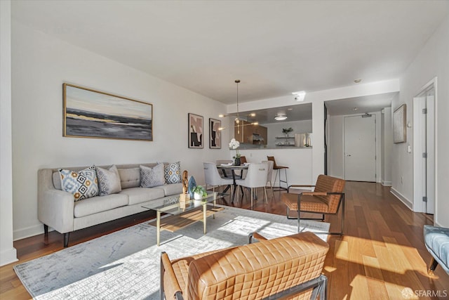 living room with an inviting chandelier and hardwood / wood-style flooring