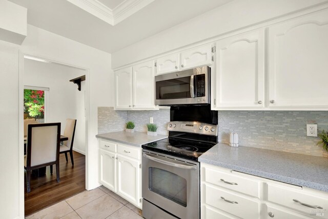 1723 Astoria Dr, Fairfield, CA 94534 - kitchen with stainless steel appliances, crown molding, white cabinets, and tasteful backsplash