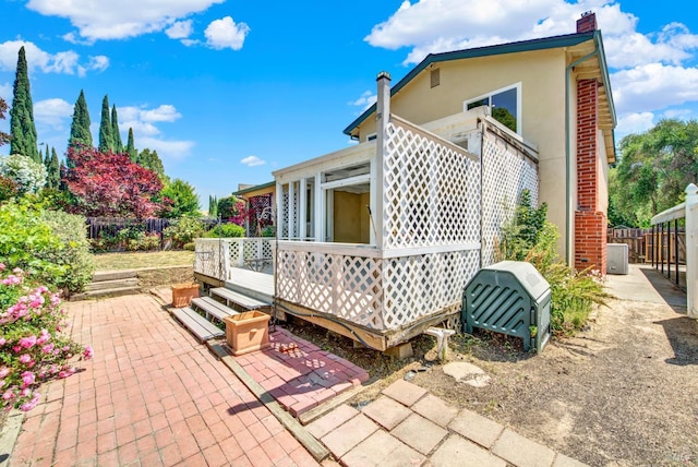 1723 Astoria Dr, Fairfield, CA 94534 - view of property exterior featuring a patio, a chimney, stucco siding, and a wooden deck