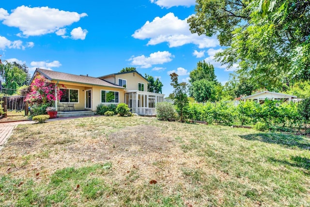 1723 Astoria Dr, Fairfield, CA 94534 - back of property with a sunroom, stucco siding, and a yard