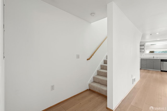 staircase with hardwood / wood-style floors