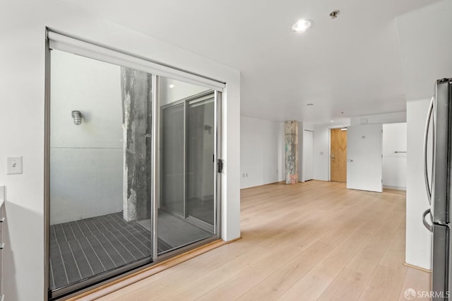 interior space with hardwood / wood-style flooring and an enclosed shower