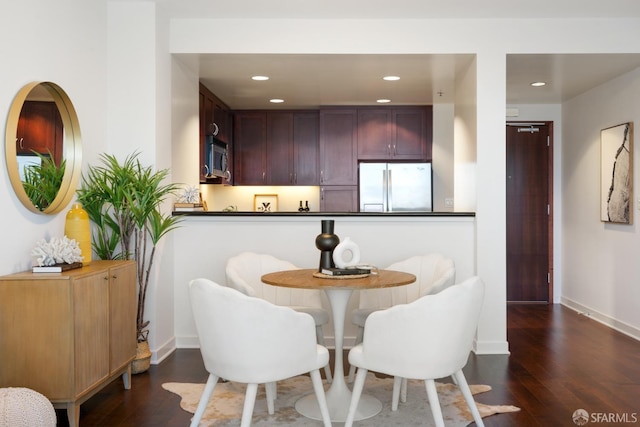 kitchen with stainless steel appliances, dark countertops, recessed lighting, wood finished floors, and baseboards