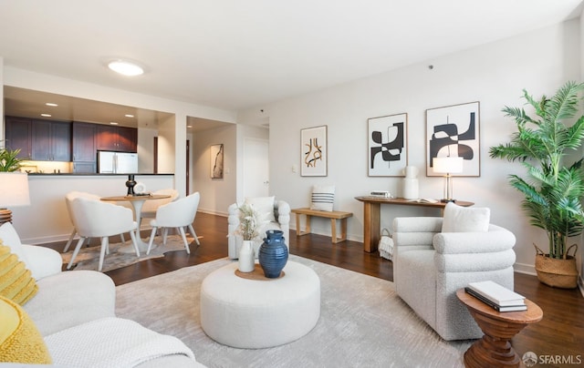 living room with baseboards and wood finished floors