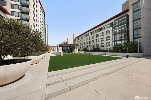 view of property's community featuring a yard