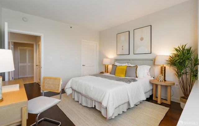 bedroom with wood finished floors and baseboards