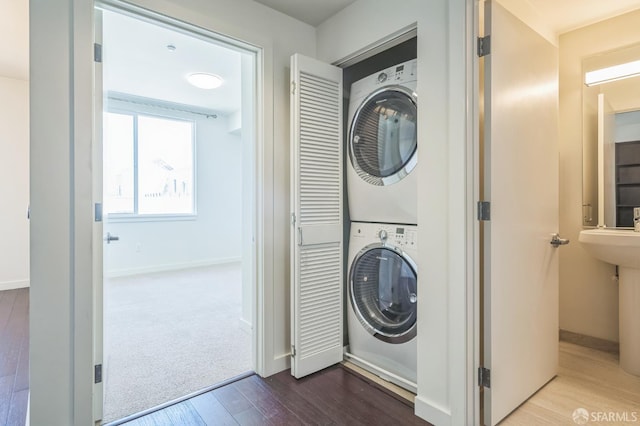 50 Jerrold Ave Unit 305, San Francisco, CA 94124 - laundry area featuring stacked washing machine and dryer, baseboards, and dark wood-style floors
