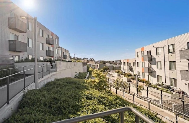 view of property's community featuring a residential view and fence