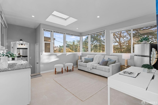 living room featuring a skylight and sink