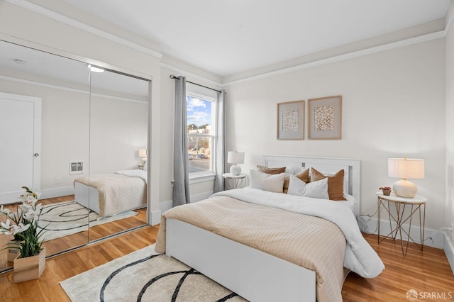 bedroom featuring wood-type flooring and ornamental molding