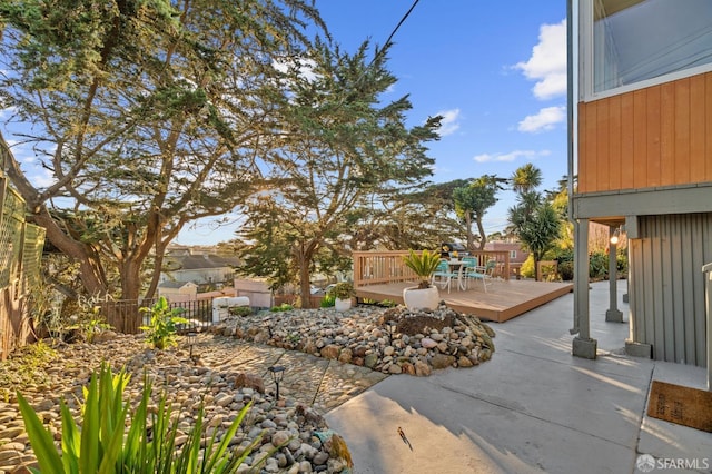 view of yard with a patio area and a wooden deck