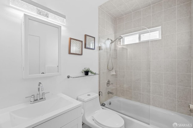 full bathroom featuring vanity, toilet, and tiled shower / bath