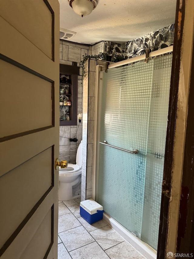 bathroom featuring toilet, an enclosed shower, tile patterned floors, tile walls, and a textured ceiling