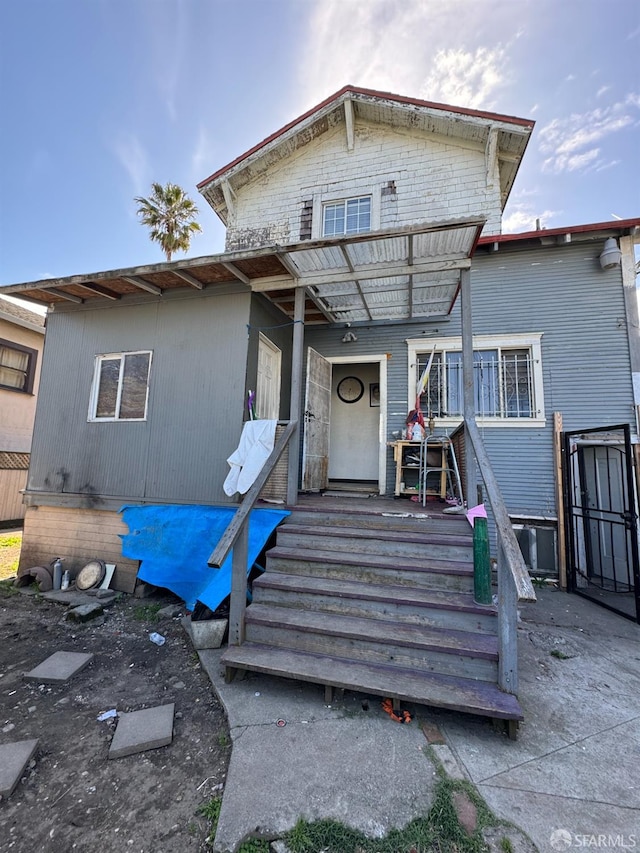 back of property featuring a wooden deck