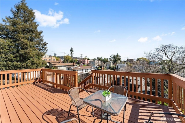 deck featuring a residential view and outdoor dining area