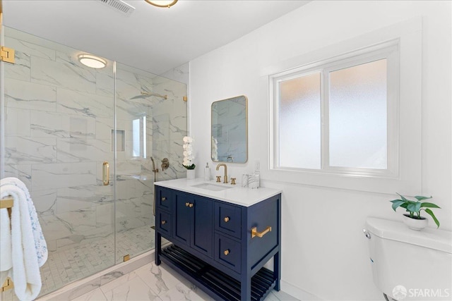 bathroom featuring marble finish floor, a marble finish shower, visible vents, toilet, and vanity