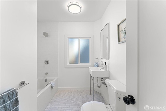 full bath with a sink, bathtub / shower combination, toilet, and baseboards