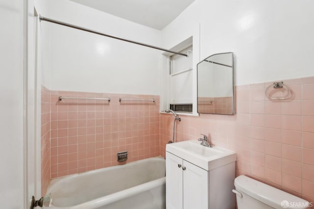 1915 Laguna St Unit 2, San Francisco, CA 94115 - full bath featuring tile walls, wainscoting, bathtub / shower combination, vanity, and toilet