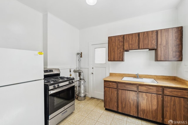 1915 Laguna St Unit 2, San Francisco, CA 94115 - kitchen featuring gas stove, light countertops, freestanding refrigerator, and a sink