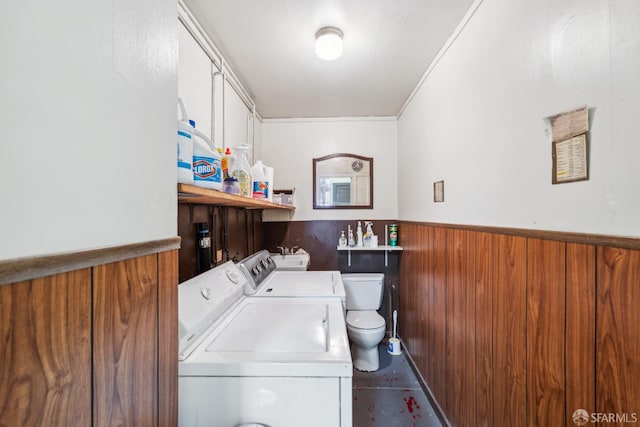 1915 Laguna St Unit 2, San Francisco, CA 94115 - washroom featuring laundry area, crown molding, wooden walls, a wainscoted wall, and separate washer and dryer