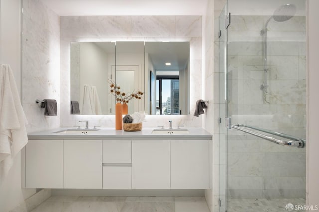 bathroom featuring vanity and a shower with door