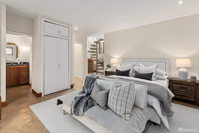 762 Bay St, San Francisco, CA 94109 - bedroom with concrete flooring, ensuite bathroom, recessed lighting, baseboards, and a sink