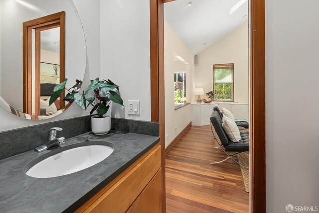 762 Bay St, San Francisco, CA 94109 - bathroom featuring wood finished floors, vanity, and lofted ceiling