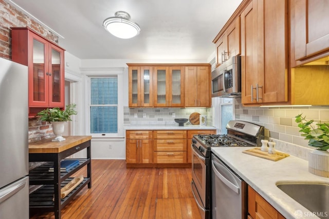 47 Octavia St, San Francisco, CA 94102 - kitchen featuring light countertops, tasteful backsplash, hardwood / wood-style flooring, and stainless steel appliances