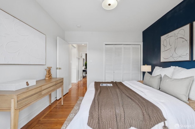 bedroom featuring wood finished floors and a closet