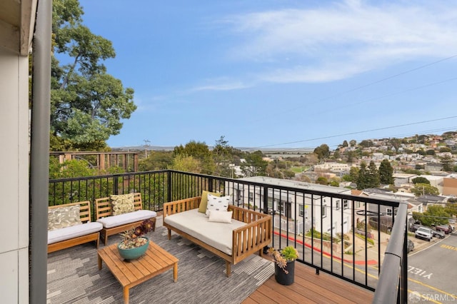 wooden terrace with an outdoor living space