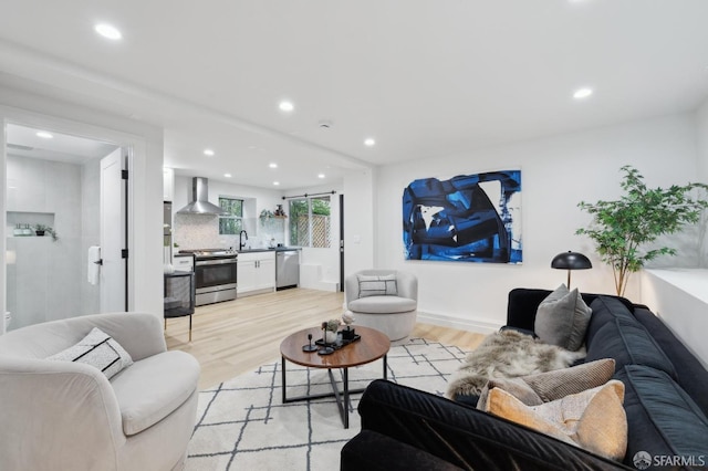 living area featuring light wood-style flooring and recessed lighting