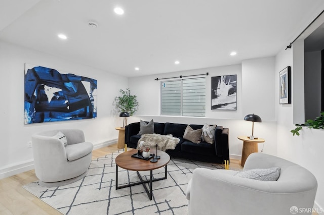 living area with recessed lighting, baseboards, and wood finished floors