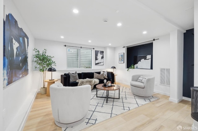 living room with visible vents, recessed lighting, baseboards, and wood finished floors