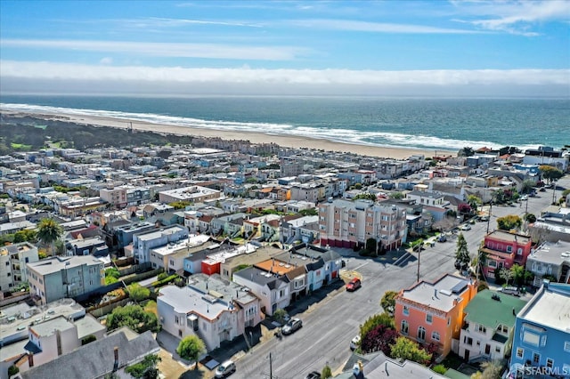 birds eye view of property featuring a water view and a view of the beach