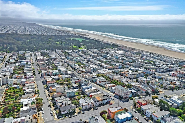 drone / aerial view featuring a water view and a view of the beach