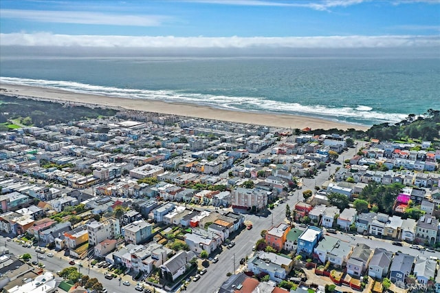 drone / aerial view with a water view and a beach view