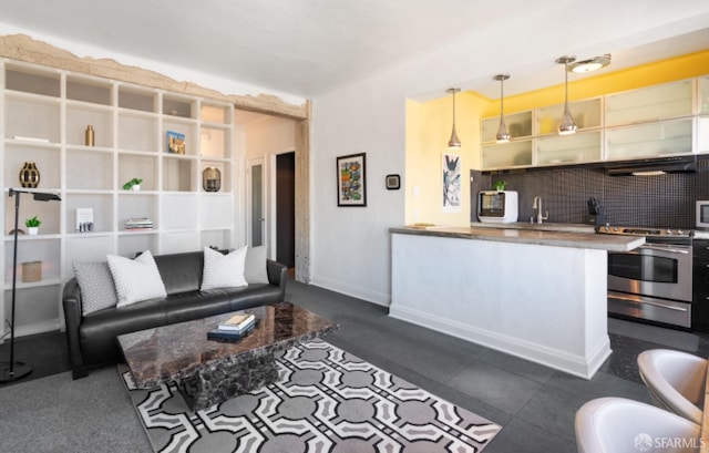 living room with dark tile patterned flooring and sink