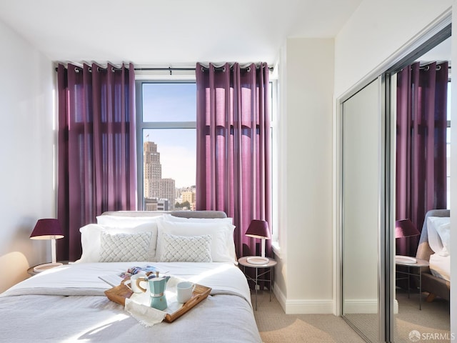 bedroom featuring light carpet