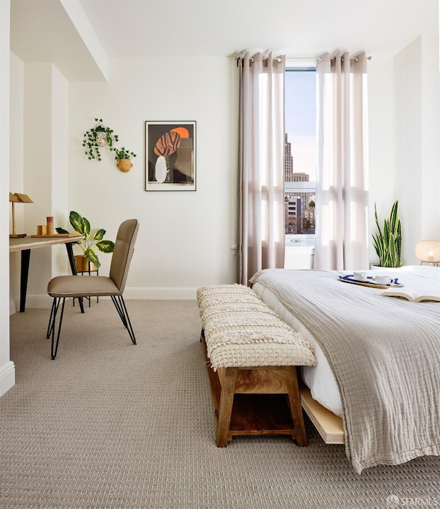 bedroom featuring light colored carpet and expansive windows