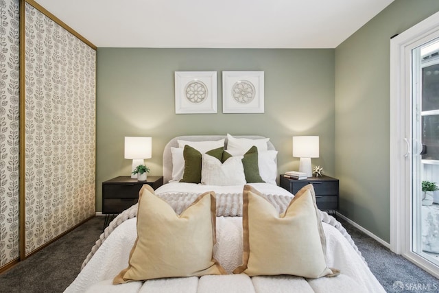 bedroom featuring baseboards, carpet flooring, and access to exterior