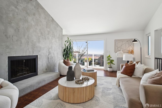 living area featuring a high end fireplace, wood finished floors, and baseboards