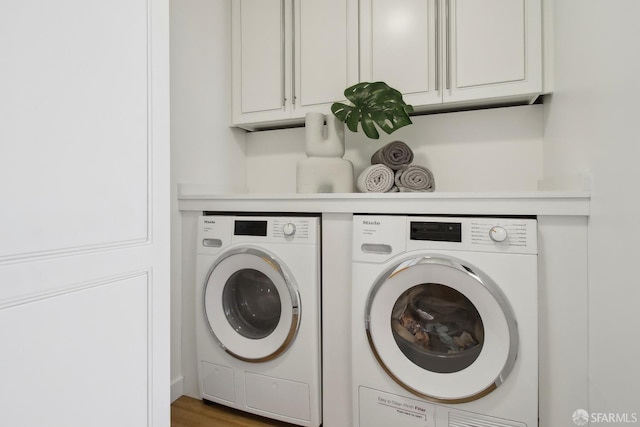 laundry area featuring washing machine and dryer and cabinet space