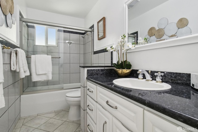 bathroom with combined bath / shower with glass door, vanity, marble finish floor, and toilet